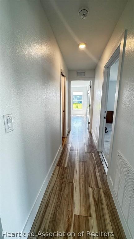 hall with dark wood-type flooring