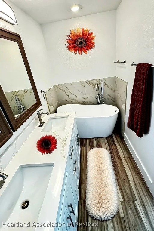 bathroom with vanity and a tub