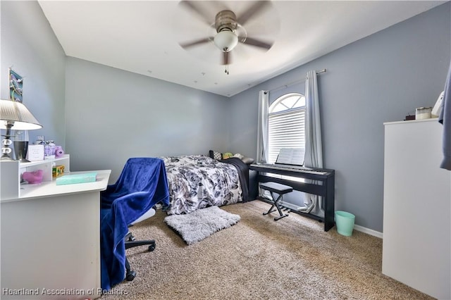 bedroom with light carpet, a ceiling fan, and baseboards