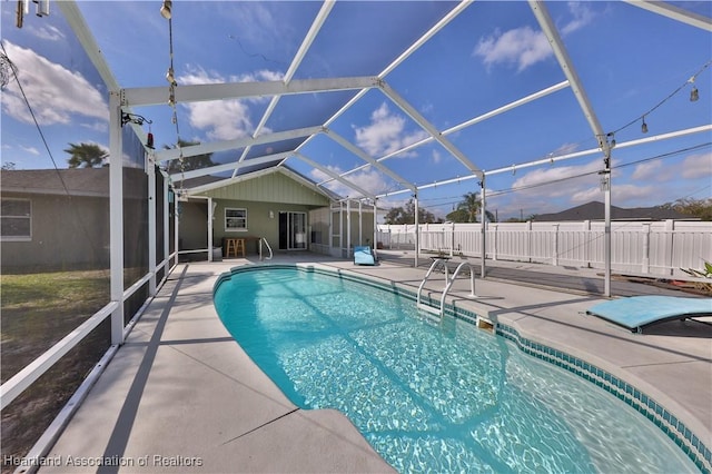 view of pool with a fenced in pool, a lanai, a patio, and fence