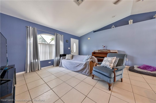 living area featuring lofted ceiling, light tile patterned floors, baseboards, and visible vents