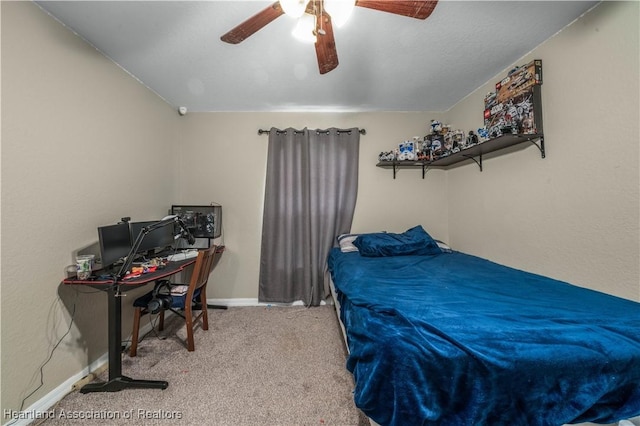 carpeted bedroom with a ceiling fan and baseboards