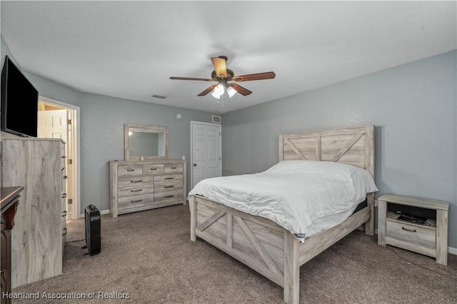 carpeted bedroom featuring baseboards, visible vents, and a ceiling fan