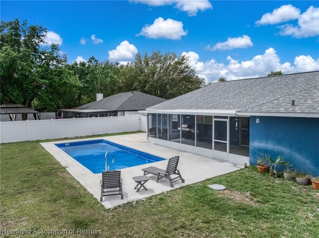 view of swimming pool featuring a fenced in pool, a lawn, a sunroom, a patio area, and a fenced backyard