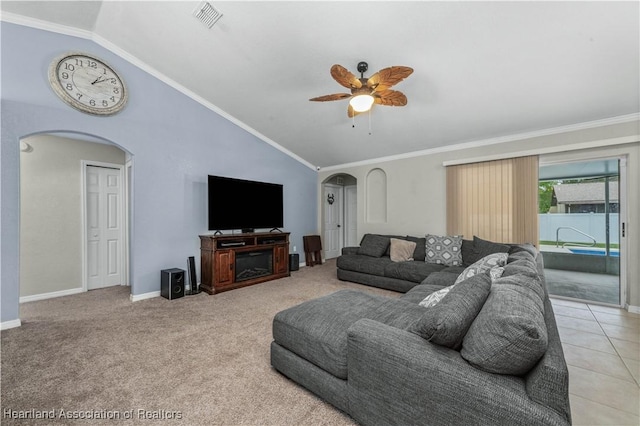 living room featuring arched walkways, ornamental molding, lofted ceiling, and visible vents