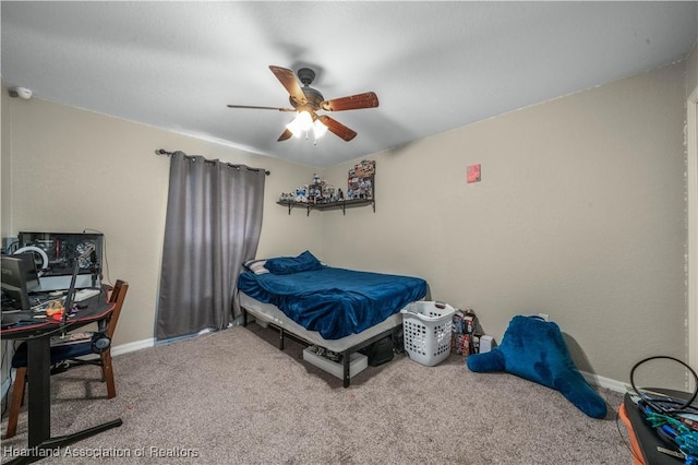 carpeted bedroom featuring baseboards and a ceiling fan