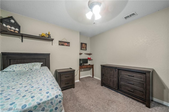 bedroom with baseboards, a ceiling fan, visible vents, and light colored carpet