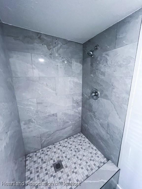 bathroom with tiled shower