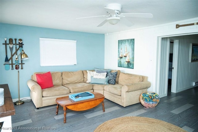 living room featuring dark wood-style floors, ceiling fan, and baseboards