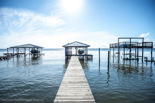 dock area with a water view and boat lift