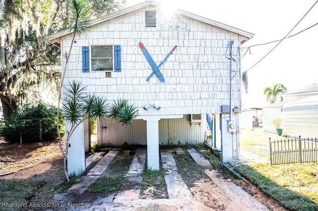 view of front of house with a carport and fence