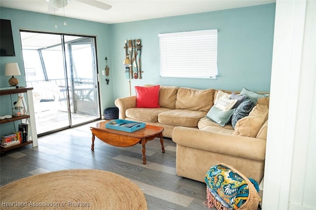 living area with wood finished floors and a ceiling fan