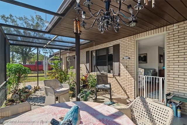 view of patio / terrace featuring a lanai