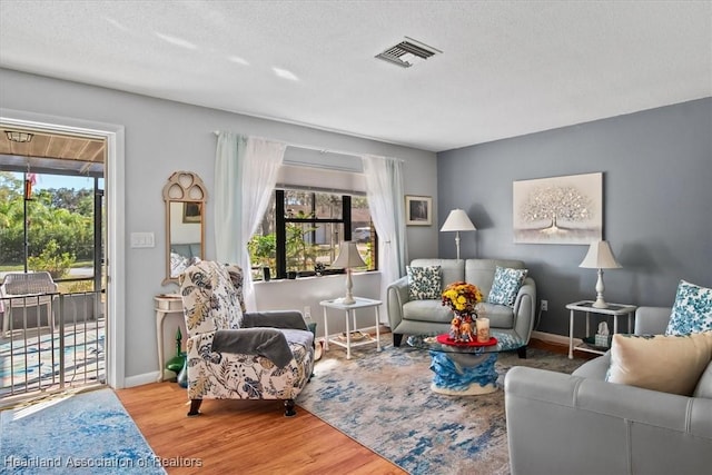 sitting room featuring light hardwood / wood-style floors and a textured ceiling