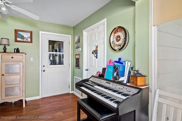 miscellaneous room with ceiling fan and dark hardwood / wood-style flooring