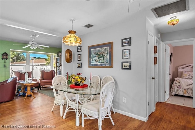 dining room with hardwood / wood-style floors and ceiling fan