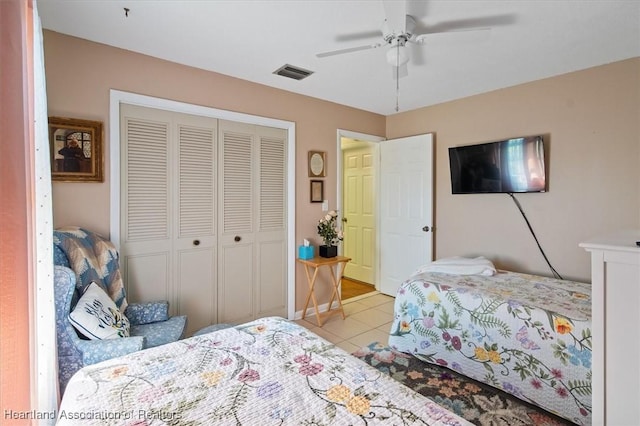 tiled bedroom featuring a closet and ceiling fan