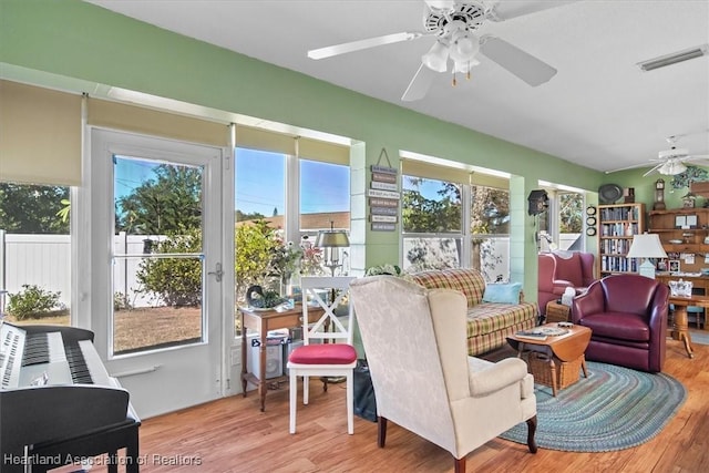 sunroom featuring ceiling fan