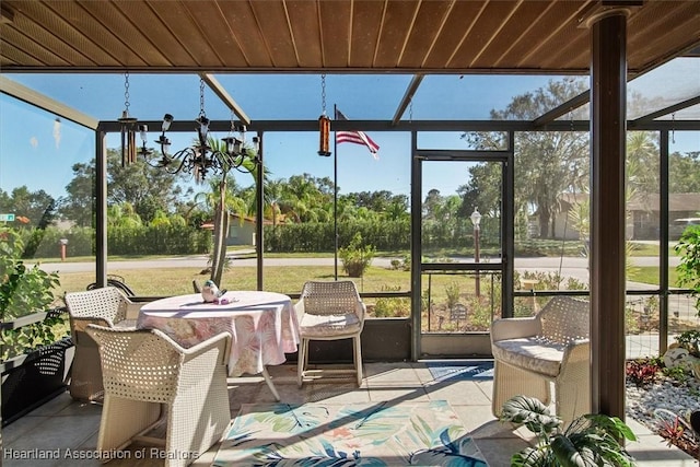 sunroom / solarium with a chandelier