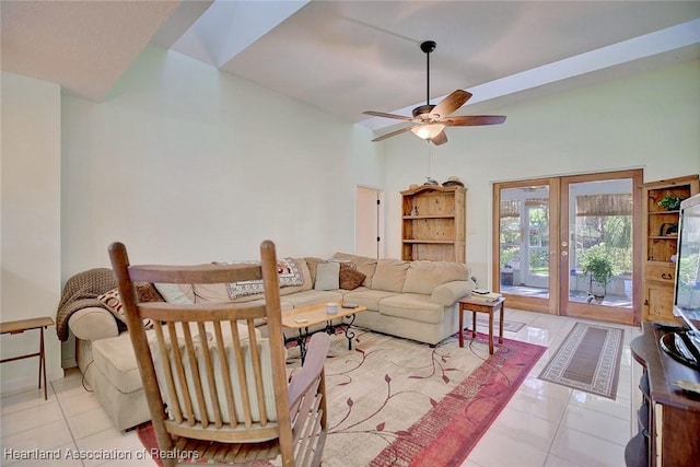 living room featuring ceiling fan, french doors, light tile patterned floors, and a high ceiling