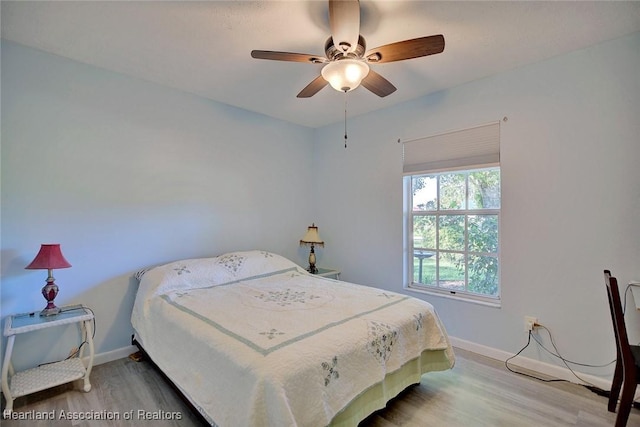 bedroom featuring ceiling fan and wood-type flooring