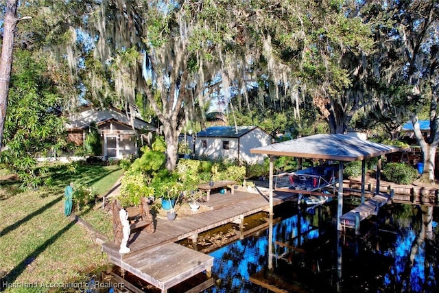 dock area featuring a lawn and a water view