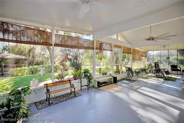 unfurnished sunroom featuring ceiling fan and vaulted ceiling