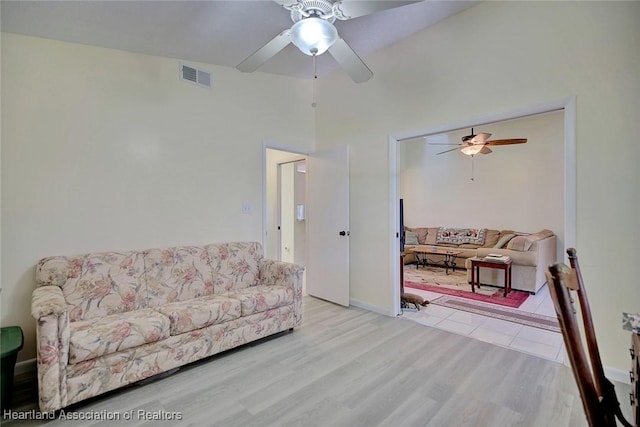 living room featuring light hardwood / wood-style flooring and ceiling fan