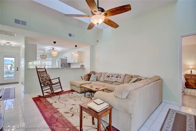 tiled living room with high vaulted ceiling and ceiling fan