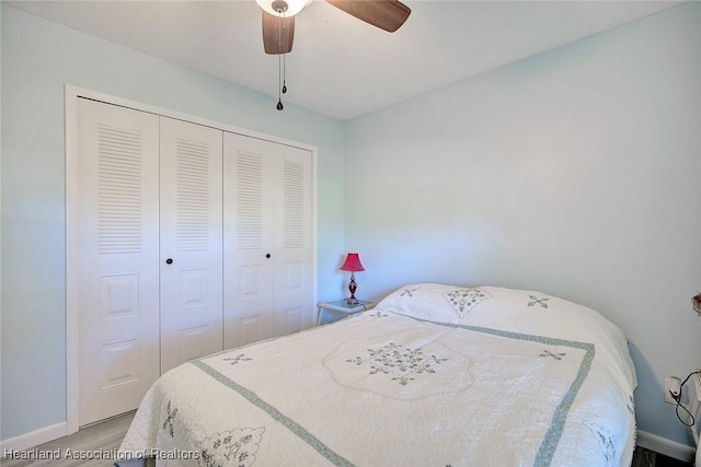 carpeted bedroom featuring a closet and ceiling fan