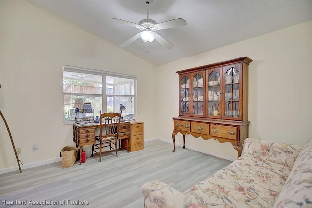 office area featuring ceiling fan, light hardwood / wood-style floors, and vaulted ceiling