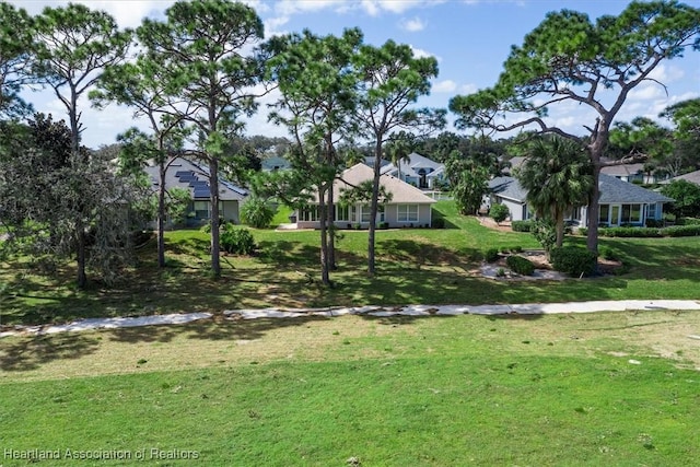 view of home's community featuring a lawn