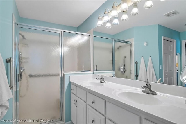 bathroom featuring vanity and an enclosed shower