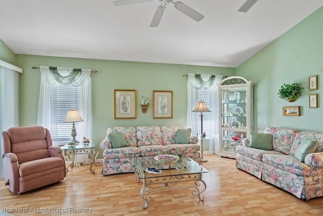 living room with ceiling fan and light hardwood / wood-style flooring