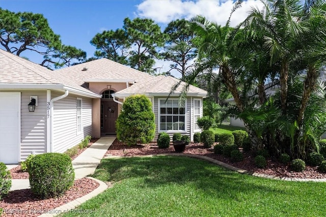 view of front facade featuring a garage and a front yard