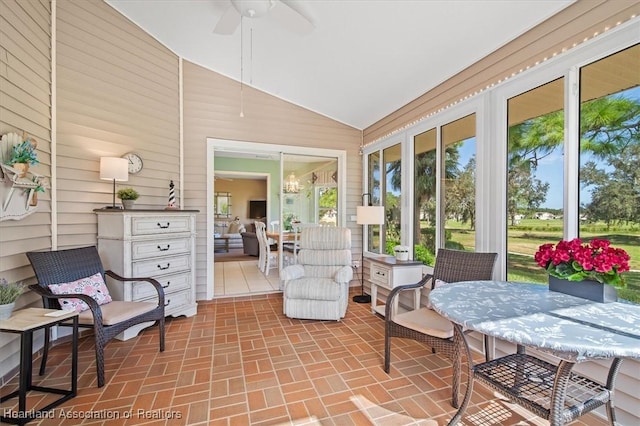 sunroom featuring vaulted ceiling and ceiling fan