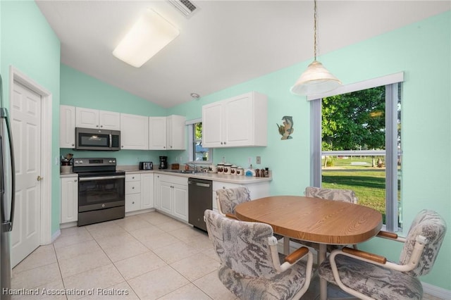 kitchen featuring white cabinets, a sink, visible vents, lofted ceiling, and appliances with stainless steel finishes