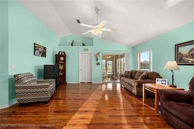 living area with lofted ceiling, wood finished floors, ceiling fan, and visible vents