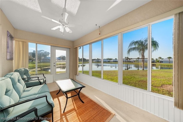 sunroom / solarium with a skylight, a water view, and ceiling fan