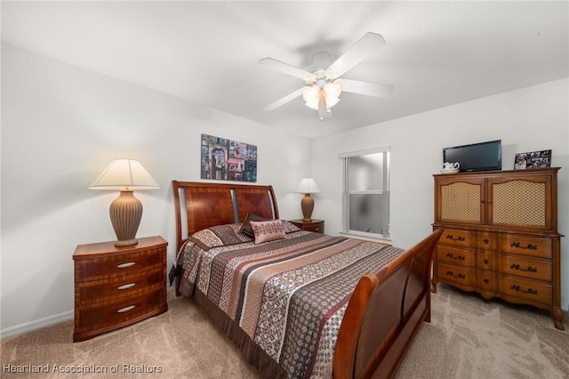 bedroom with baseboards, a ceiling fan, and carpet