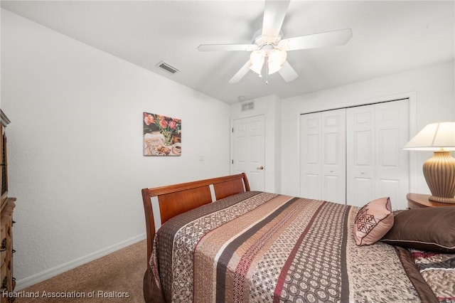 bedroom with a closet, carpet, visible vents, and baseboards