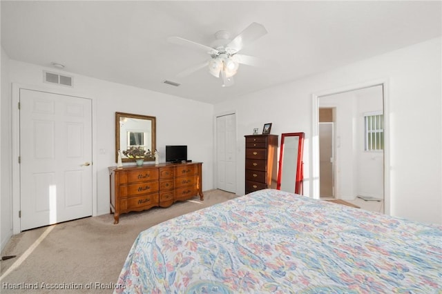 bedroom with light colored carpet, ceiling fan, and visible vents