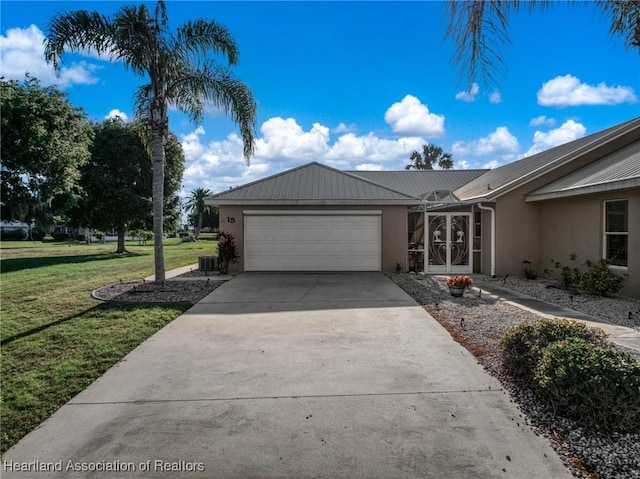 single story home featuring stucco siding, an attached garage, driveway, a front yard, and metal roof
