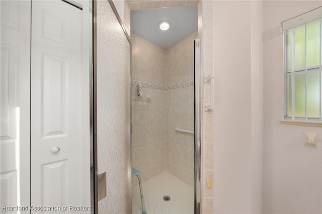 full bath with a shower stall and a healthy amount of sunlight