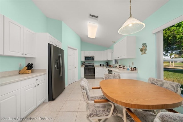 kitchen featuring lofted ceiling, visible vents, white cabinetry, and appliances with stainless steel finishes