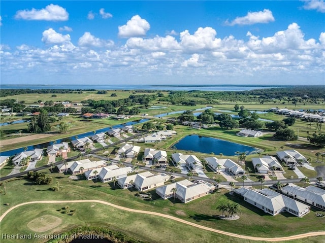 aerial view featuring golf course view, a water view, and a residential view