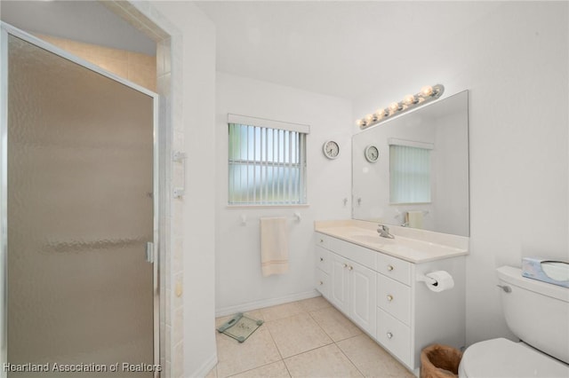 full bathroom featuring tile patterned floors, toilet, baseboards, a shower stall, and vanity