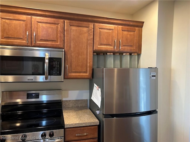 2131 Lakeview Dr Unit 400, Sebring, FL 33870 - kitchen with appliances with stainless steel finishes, brown cabinets, and light countertops