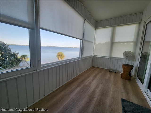 2131 Lakeview Dr Unit 400, Sebring, FL 33870 - unfurnished sunroom featuring a water view, wood finished floors, and healthy amount of natural light
