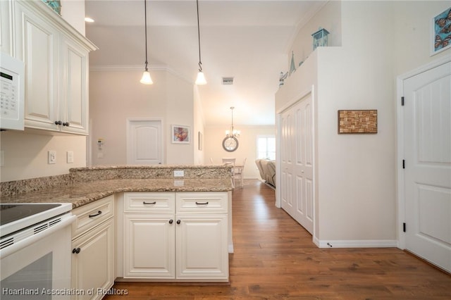 kitchen featuring pendant lighting, white cabinetry, wood-type flooring, kitchen peninsula, and crown molding